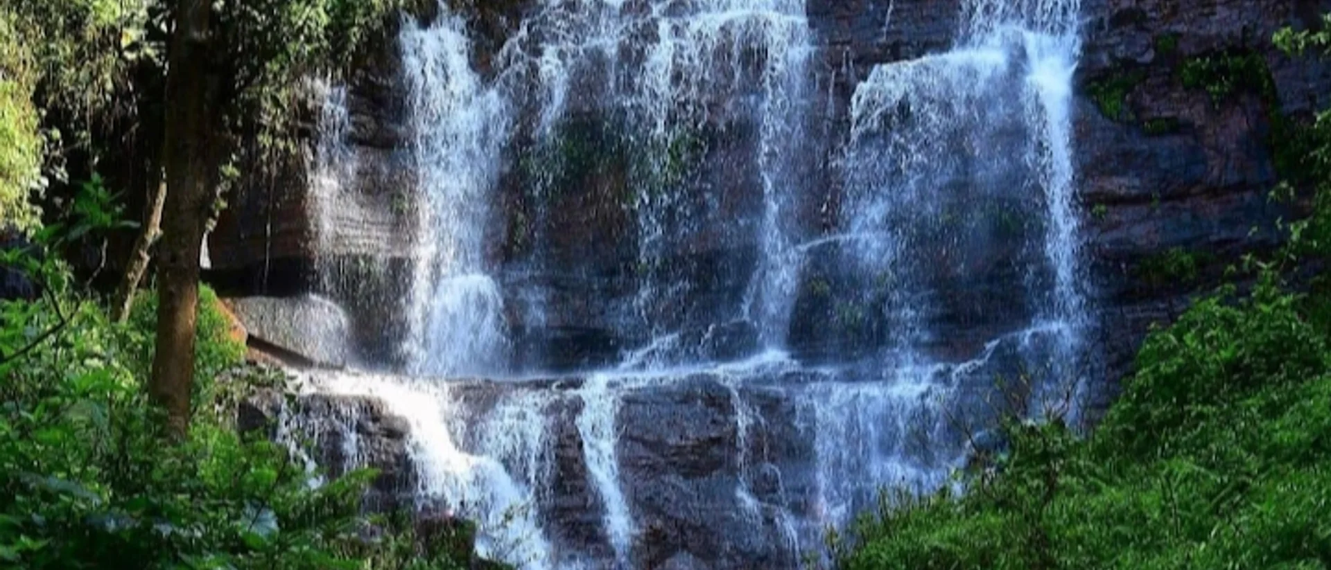 Jhari Falls, also known as Buttermilk or Dabdabe Falls, cascading in segmented tiers over the rock face